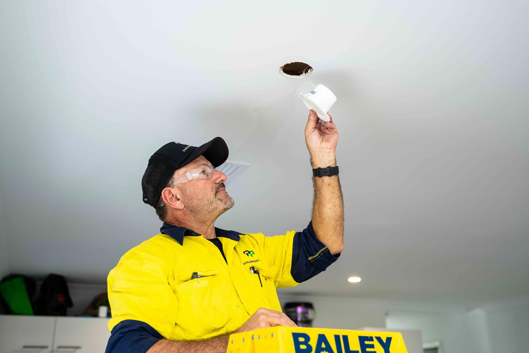 Electrician holding downlight