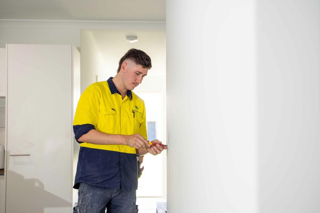 Electrician working on wall plate